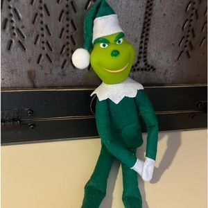 Green grinch on the fireplace